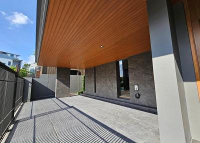 Modern building entrance with wooden ceiling and stone walls