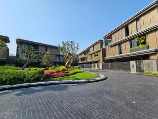 Modern residential buildings with landscaped garden and paved entrance