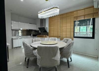 Modern kitchen with dining area and elegant lighting