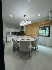 Modern kitchen with dining area and elegant lighting