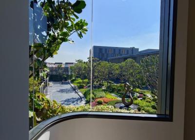 A view from a building window overlooking landscaped gardens