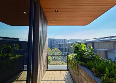 Spacious balcony with wooden ceiling and urban view