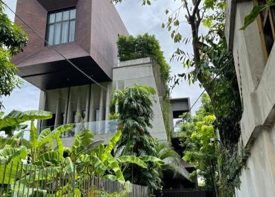Modern multi-story building with lush greenery