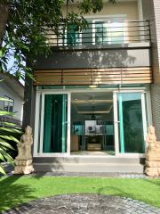 Modern two-story house with large windows and balcony