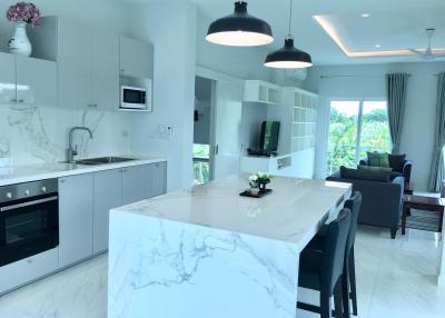 Modern kitchen with open plan layout leading to the living room