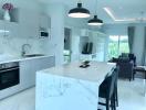 Modern kitchen with open plan layout leading to the living room