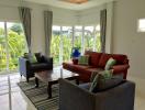 Spacious and Bright Living Room with Large Windows and Comfortable Seating
