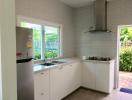 Modern kitchen with stainless steel appliances and tiled flooring