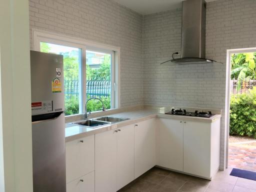 Modern kitchen with stainless steel appliances and tiled flooring