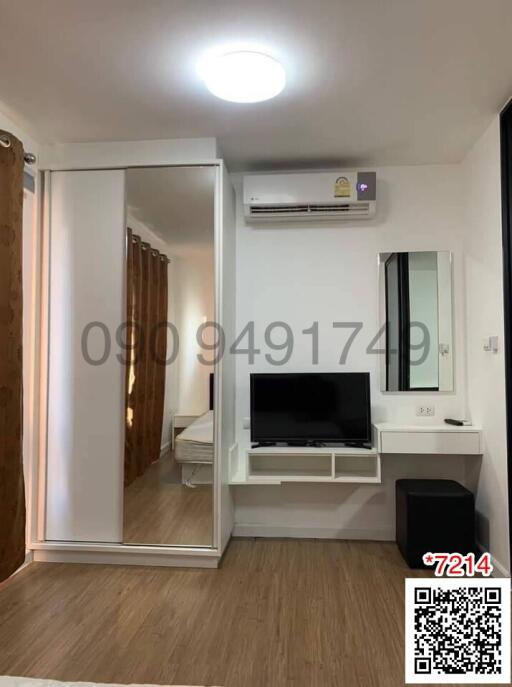 Modern bedroom with a large wardrobe, TV, and air conditioning unit