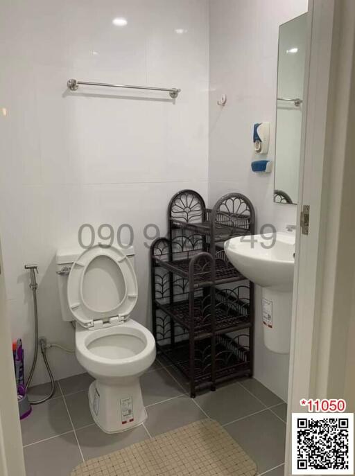 Modern white bathroom with toilet and storage shelves