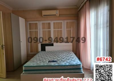 Spacious bedroom with king-sized bed, built-in closets and air conditioning