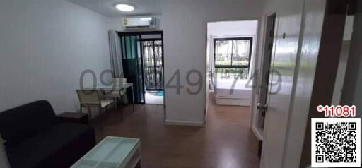 Spacious living room with tiled flooring and natural light