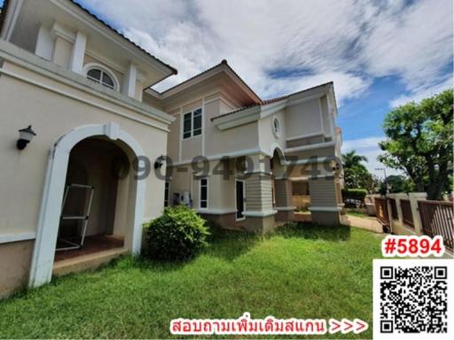 Two-story suburban home with spacious yard and clear skies