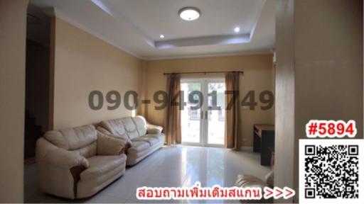 Spacious and well-lit living room with comfortable seating and large windows