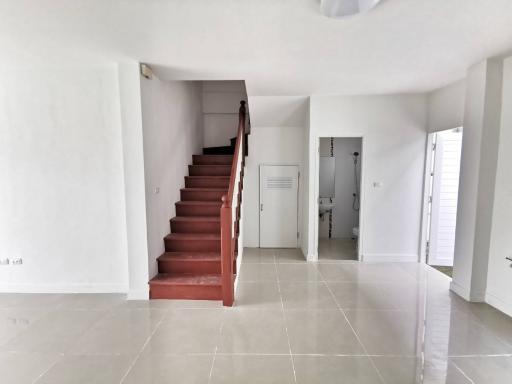 Spacious living room with staircase and tiled flooring