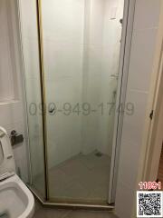 Small bathroom with glass shower enclosure and toilet