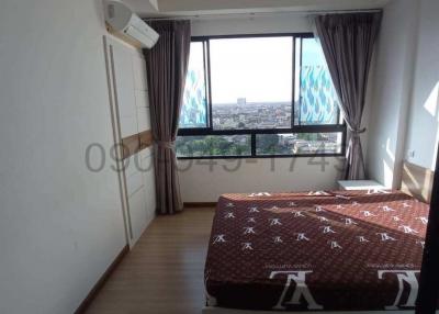 Cozy bedroom with natural light and city view