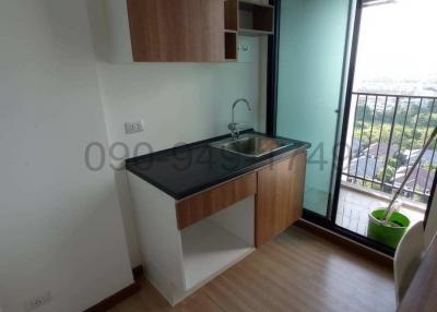 Compact modern kitchen with balcony access