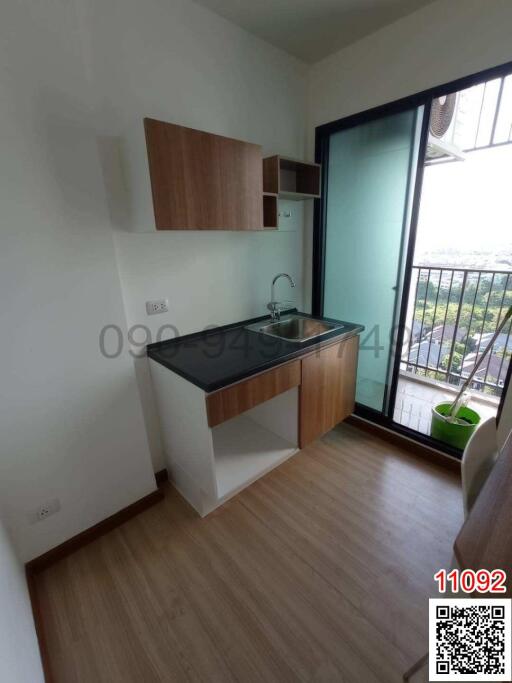 Compact modern kitchen with balcony access