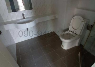 Compact modern bathroom with wall-mounted sink and toilet