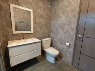 Modern bathroom with marble tiles and sleek fixtures