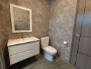 Modern bathroom with marble tiles and sleek fixtures