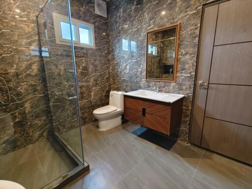 Modern bathroom with marble tiles and glass shower