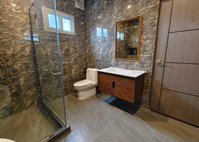 Modern bathroom with marble tiles and glass shower