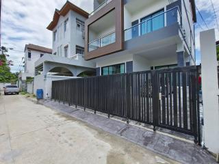 Modern two-story house with a gated entrance