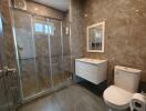 Modern bathroom with glass shower and elegant tiling