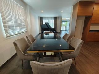 Spacious living room with dining area and grand piano