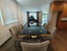 Spacious living room with dining area and grand piano