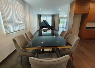 Spacious living room with dining area and grand piano