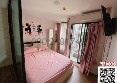 Cozy Bedroom with Mickey Mouse Wall Decal and Access to Balcony