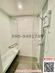 Modern tiled bathroom with shower and built-in shelf