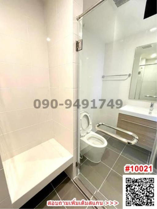 Modern bathroom interior with glass shower, toilet, and vanity