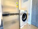 Modern utility room with a washing machine and refrigerator