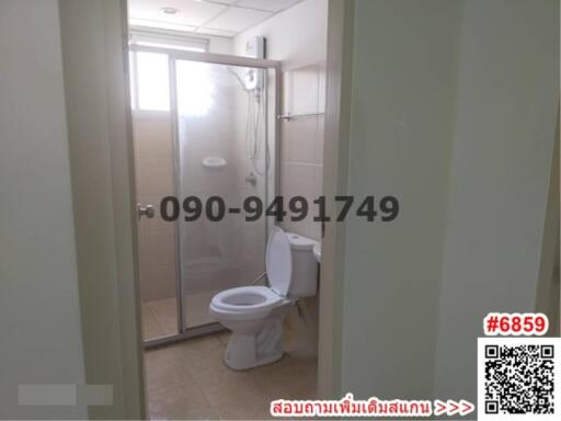 Spacious bathroom with glass shower enclosure and modern toilet