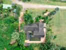 Aerial view of a tropical residential property with lush greenery