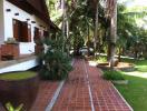Pathway leading to a house with tropical landscaping