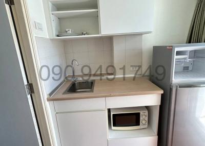 Compact kitchen with microwave and fridge
