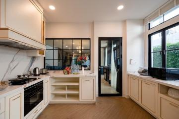 Modern kitchen with white cabinetry and stainless steel appliances