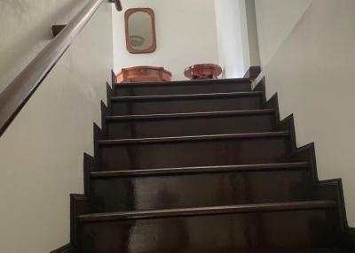 Polished wooden staircase with handrail leading to the upper floor
