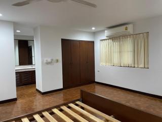 Spacious Bedroom with Wooden Flooring and Air Conditioning