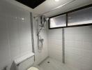 Modern tiled bathroom with shower and toilet