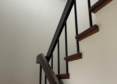 Modern Staircase with Wooden Treads and Metal Railing