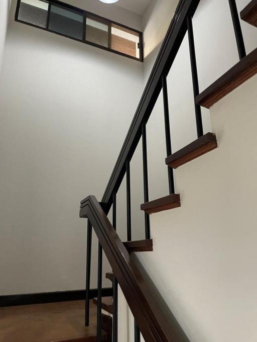 Modern Staircase with Wooden Treads and Metal Railing