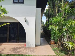 Exterior view of a modern house with lush greenery