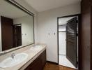 Modern bathroom interior with double vanity sinks and wooden accents